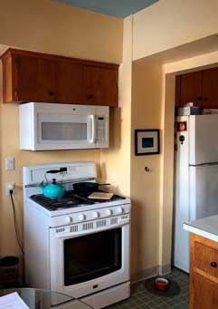 Before kitchen with outdated cabinets and appliances